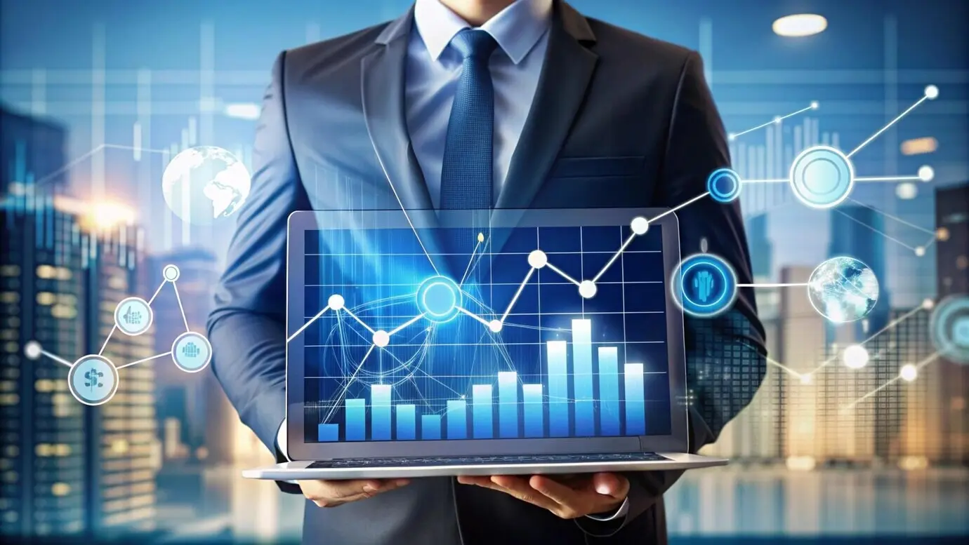 Homme d’affaires tenant un ordinateur portable affichant des données financières